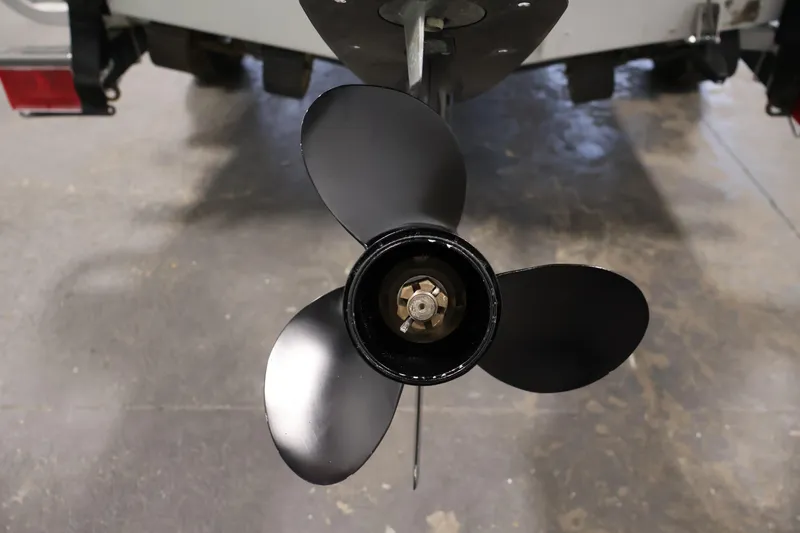 Slide: The Image of Propeller of a 1990 Lowe 1620V boat, close-up view in a garage setting. - 42