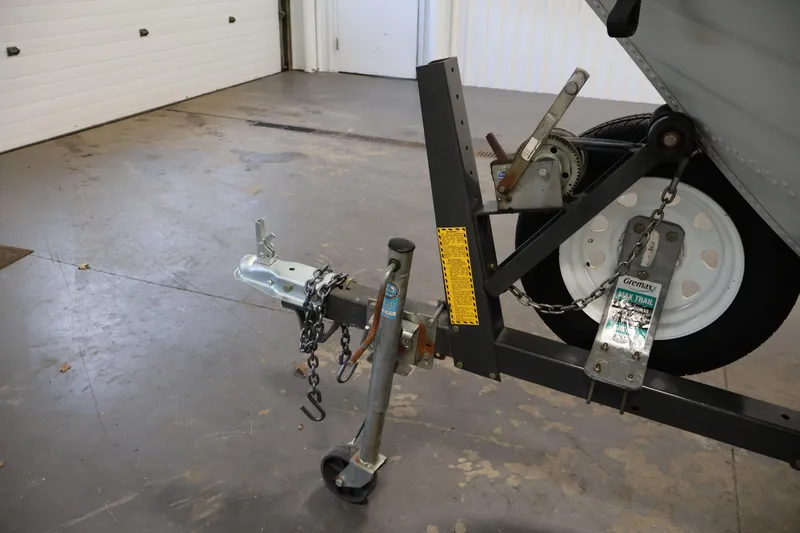 Slide: The Image of Trailer hitch and wheel assembly of a 1990 Lowe 1620V boat in a garage. - 43