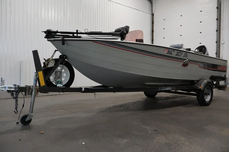 Slide: The Image of 1990 Lowe 1620V boat on trailer in indoor storage facility. - 45