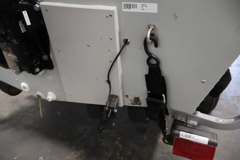 Slide: The Image of Rear view of a 1990 Lowe 1620V boat with trailer hitch and safety strap. - 50