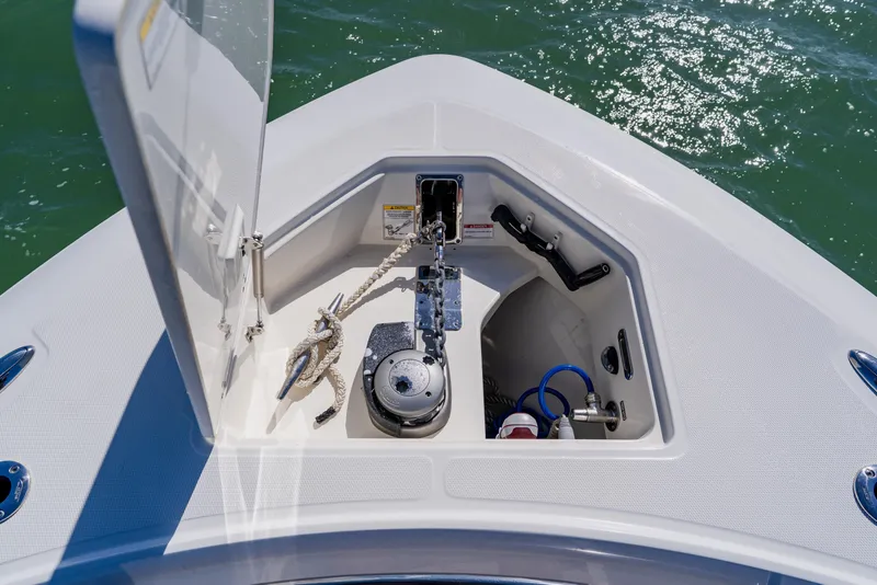 Slide: The Image of 2019 Boston Whaler 380 Outrage anchor locker with rope and winch, on calm water. - 10