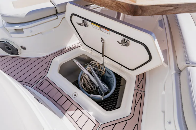 Slide: The Image of 2019 Boston Whaler 380 Outrage storage compartment with ropes and anchor. - 11