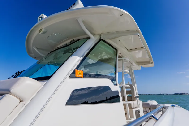 Slide: The Image of 2019 Boston Whaler 380 Outrage boat on clear blue water under sunny sky. - 16