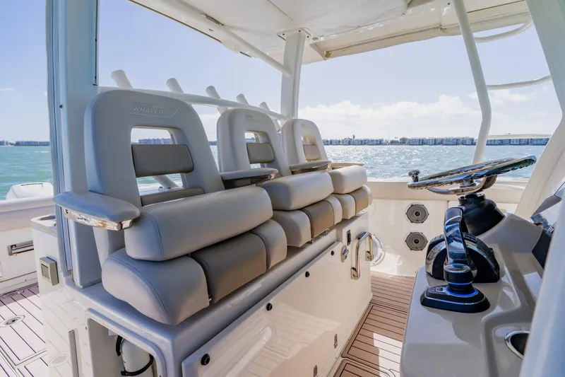 Slide: The Image of 2019 Boston Whaler 380 Outrage helm with luxurious seating and ocean view. - 19