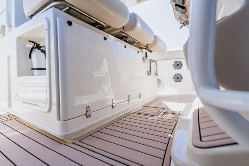 Slide: The Image of 2019 Boston Whaler 380 Outrage interior with seating and storage compartments. - 22