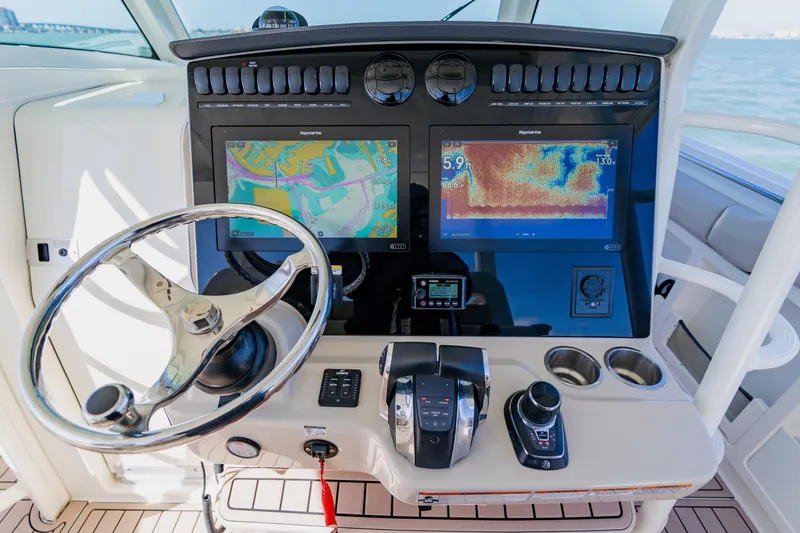 Slide: The Image of 2019 Boston Whaler 380 Outrage helm with advanced navigation displays and controls. - 24