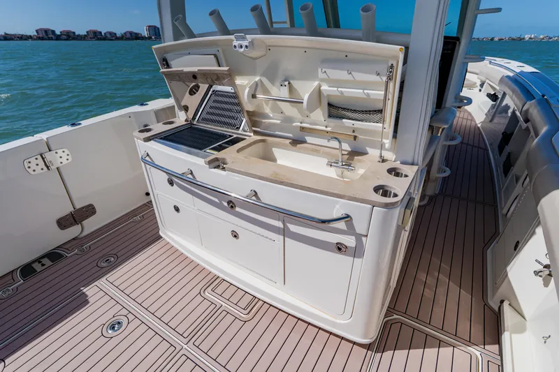 Slide: The Image of 2019 Boston Whaler 380 Outrage boat deck with outdoor kitchen and sink. - 27