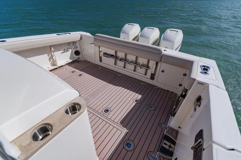 Slide: The Image of 2019 Boston Whaler 380 Outrage boat deck with triple outboard engines. - 29
