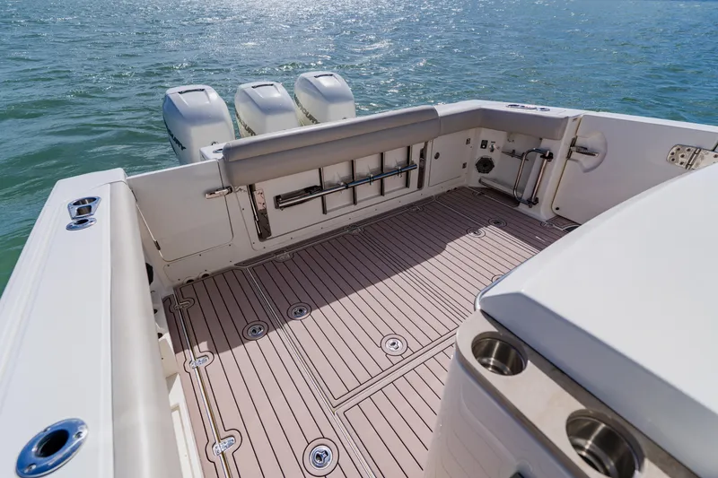 Slide: The Image of 2019 Boston Whaler 380 Outrage boat deck with triple engines on open water. - 30