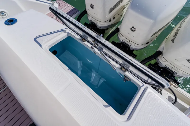 Slide: The Image of 2019 Boston Whaler 380 Outrage livewell and outboard engines on deck. - 32