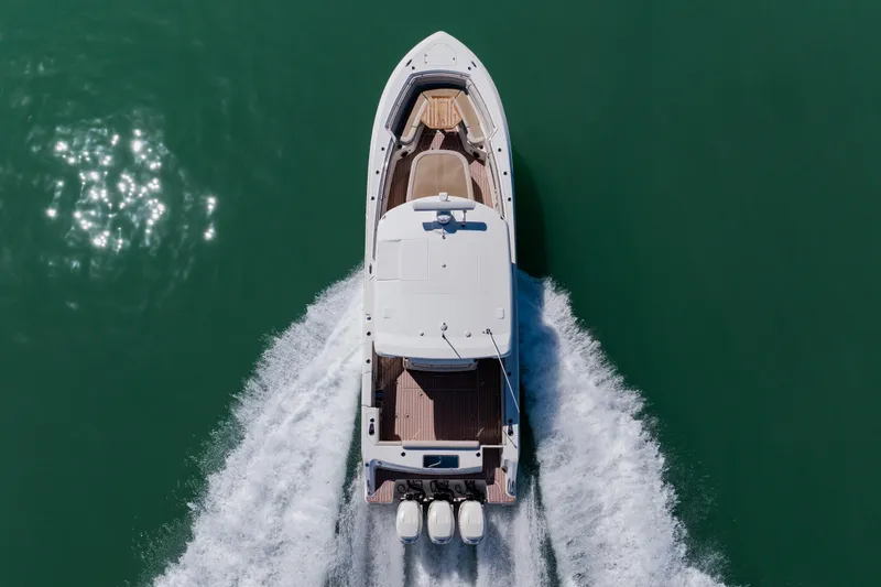Slide: The Image of Aerial view of 2019 Boston Whaler 380 Outrage cruising on green water. - 4