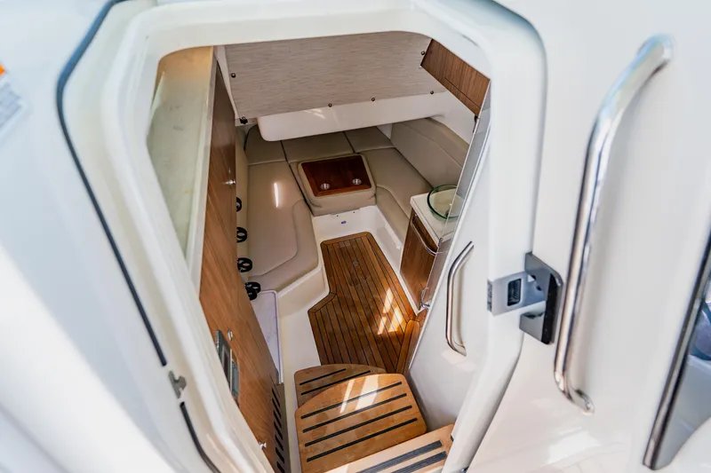 Slide: The Image of 2019 Boston Whaler 380 Outrage cabin interior with wood flooring and seating area. - 41