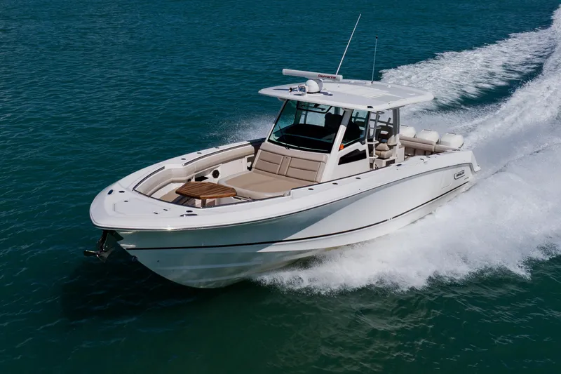 Slide: The Image of 2019 Boston Whaler 380 Outrage cruising on open water, showcasing sleek design and performance. - 5
