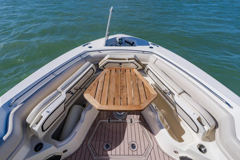 Slide: The Image of 2019 Boston Whaler 380 Outrage boat interior with wooden table and seating. - 9