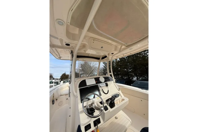 Slide: The Image of 2019 Grady-White Canyon 306 boat interior with steering wheel and control panel. - 12