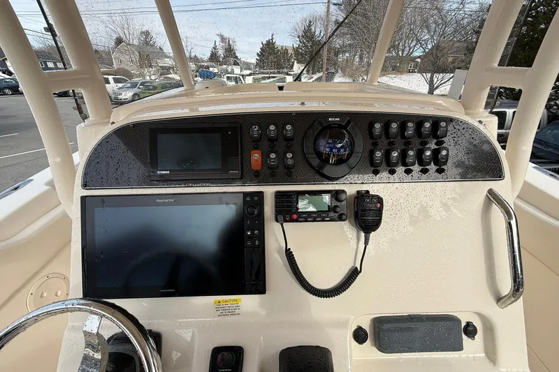 Slide: The Image of 2019 Grady-White Canyon 306 boat dashboard with navigation and communication equipment. - 14
