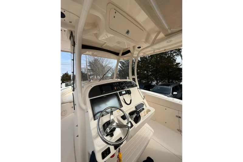 Slide: The Image of 2019 Grady-White Canyon 306 boat cockpit with steering wheel and control panel. - 15