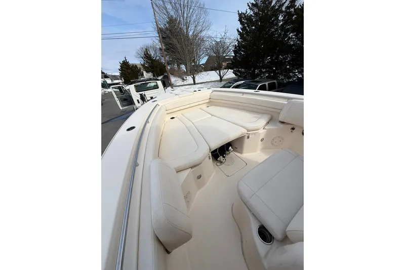 Slide: The Image of 2019 Grady-White Canyon 306 boat interior with white seating and cup holders. - 19