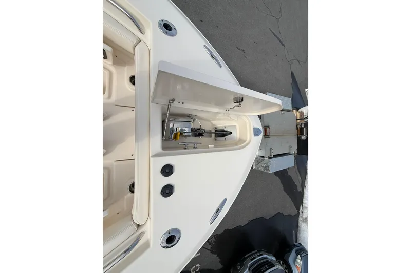 Slide: The Image of 2019 Grady-White Canyon 306 boat anchor compartment, open on a trailer. - 21