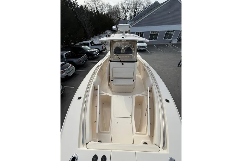 Slide: The Image of 2019 Grady-White Canyon 306 boat in parking lot, showcasing spacious deck and seating. - 22
