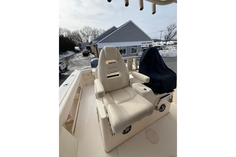 Slide: The Image of 2019 Grady-White Canyon 306 boat interior with beige seating and covered console. - 24