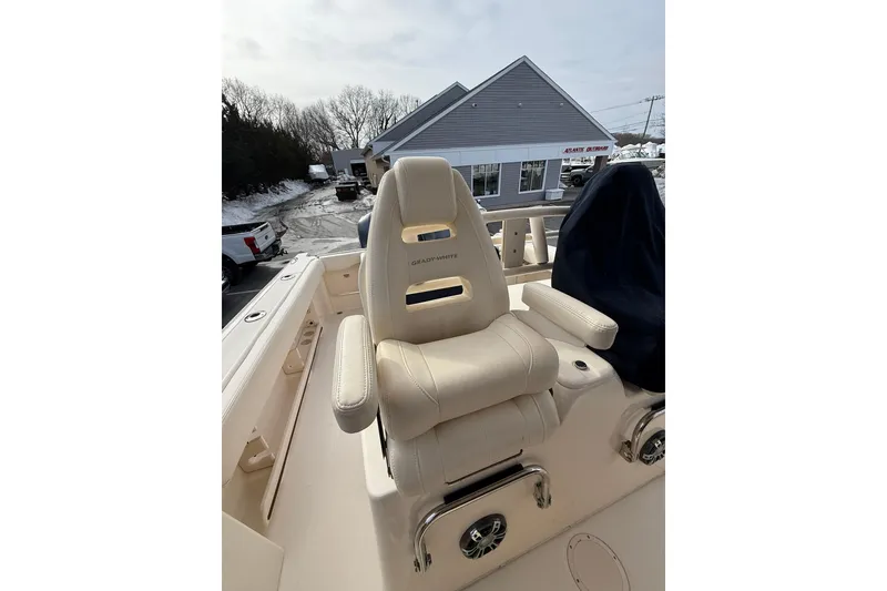 Slide: The Image of 2019 Grady-White Canyon 306 boat seat, beige leather, outdoor setting. - 25