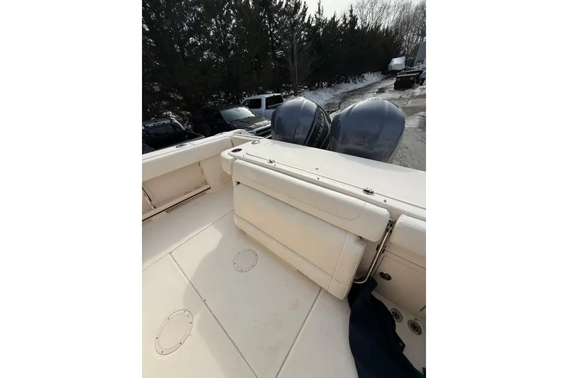 Slide: The Image of 2019 Grady-White Canyon 306 boat with dual outboard engines, parked outdoors. - 26