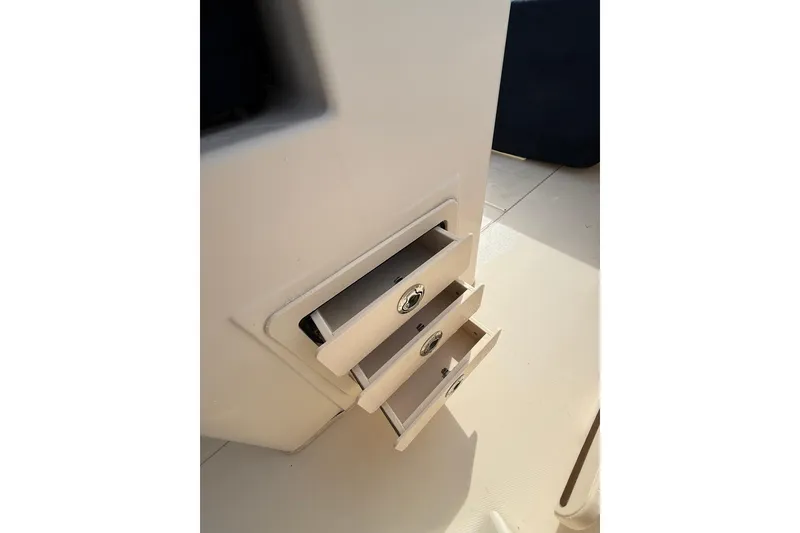 Slide: The Image of 2019 Grady-White Canyon 306 boat storage drawers, open and sunlit. - 28