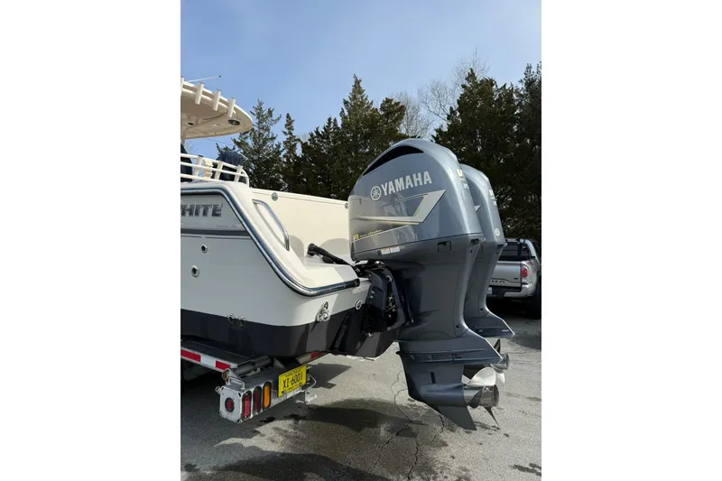 Slide: The Image of 2019 Grady-White Canyon 306 boat with Yamaha outboard engines, parked outdoors. - 30