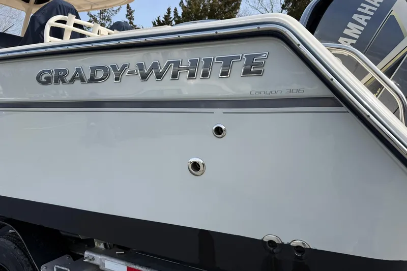 Slide: The Image of 2019 Grady-White Canyon 306 boat, side view with logo and details. - 4