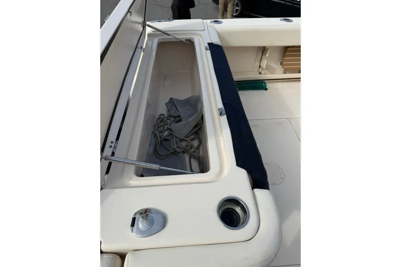 Slide: The Image of 2019 Grady-White Canyon 306 boat storage compartment with rope and cover. - 8