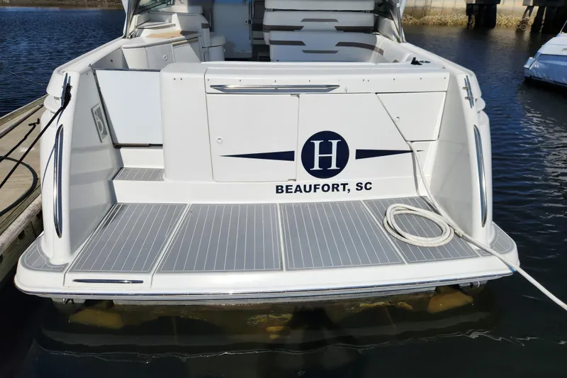 Slide: The Image of 2000 Formula 41 Performance Cruiser docked at marina, showcasing sleek design and spacious deck. - 10