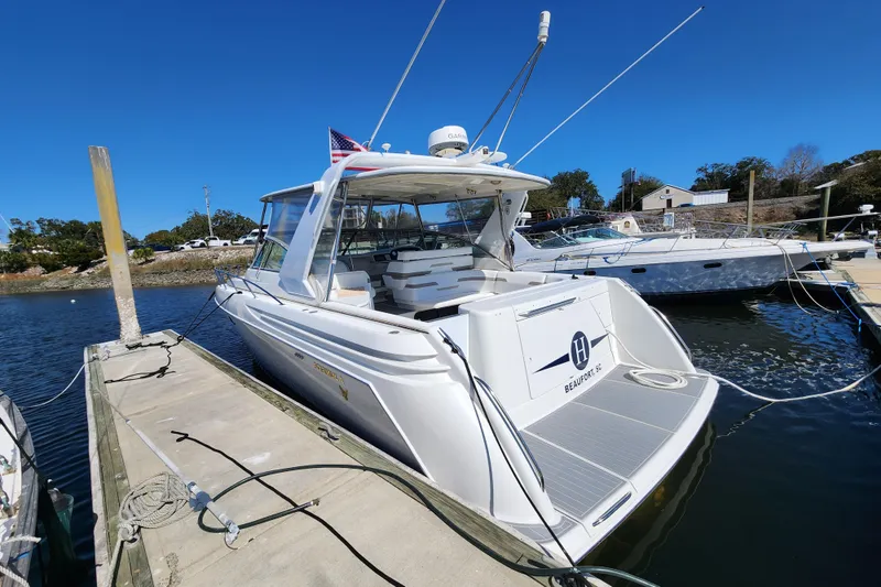 Slide: The Image of 2000 Formula 41 Performance Cruiser docked at marina under clear blue sky. - 2