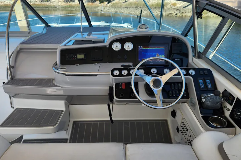 Slide: The Image of Interior of 2000 Formula 41 Performance Cruiser with open storage compartment and cleaning supplies. - 23