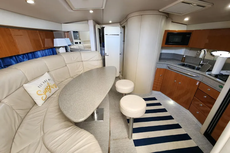 Slide: The Image of Interior of 2000 Formula 41 Performance Cruiser with seating and helm, docked by water. - 30