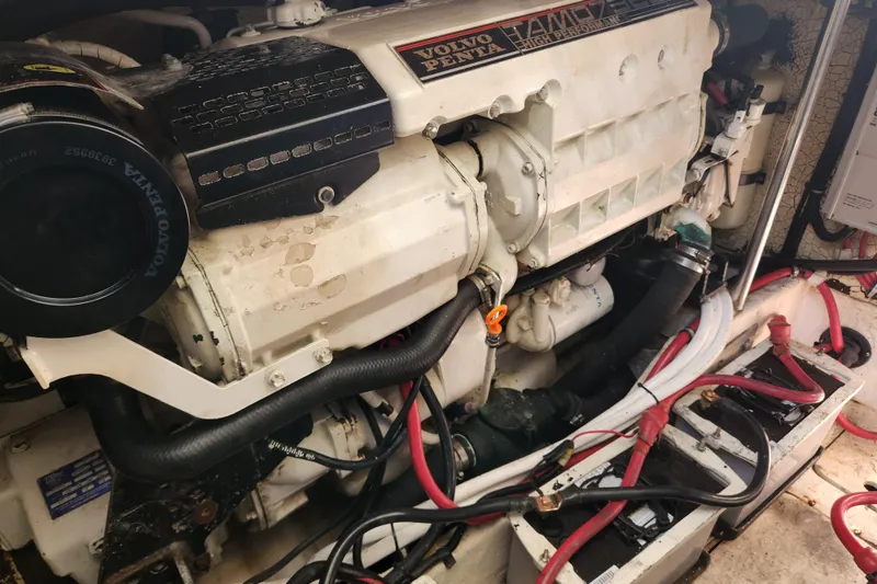 Slide: The Image of Engine room of a 2000 Formula 41 Performance Cruiser with visible machinery and fire extinguisher. - 44