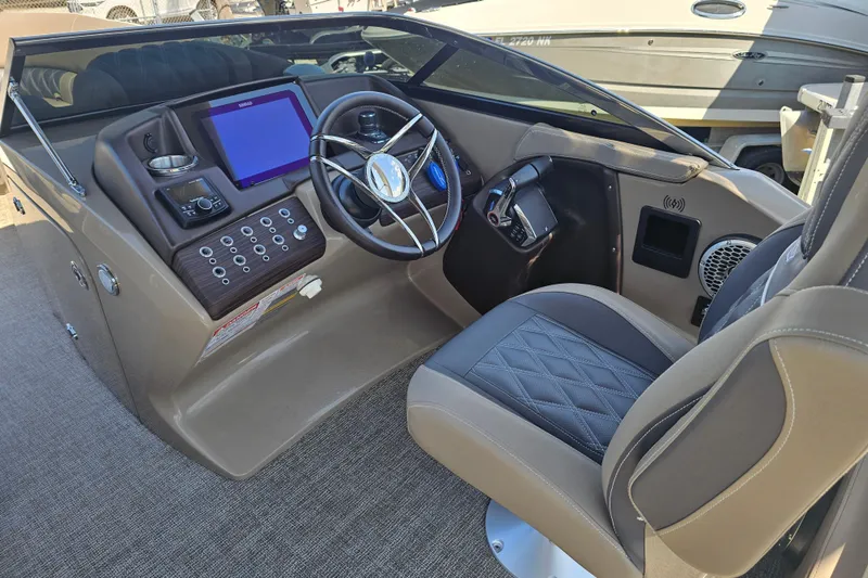 Slide: The Image of 2025 Bennington QX 27 QXSBWA X2 Swingback boat cockpit with modern controls and steering wheel. - 15