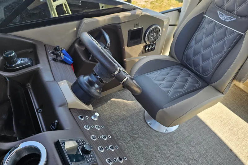 Slide: The Image of Luxurious helm of 2025 Bennington QX 27 QXSBWA X2 Swingback with premium seating and controls. - 24