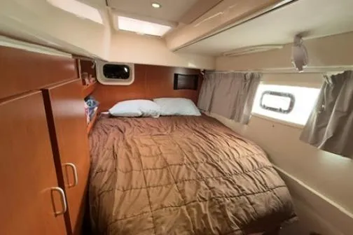 Slide: The Image of Cozy bedroom in 2014 Leopard 44 yacht with wood cabinetry and natural light. - 10
