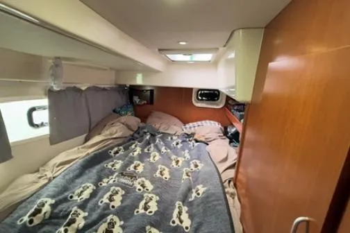 Slide: The Image of Cozy cabin interior of 2014 Leopard 44 catamaran with bed and porthole. - 11