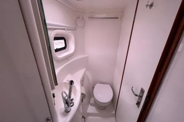 Slide: The Image of Compact bathroom in 2014 Leopard 44 yacht with toilet, sink, and porthole. - 14