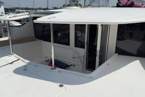 Slide: The Image of 2014 Leopard 44 catamaran cockpit with white canopy and seating area. - 21