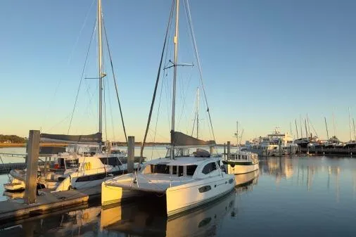 Slide: The Image of 2014 Leopard 44 catamaran docked at a serene marina during sunset. - 27