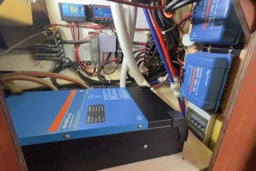 Slide: The Image of Electrical system setup in a 2014 Leopard 44, featuring wiring and blue power units. - 33