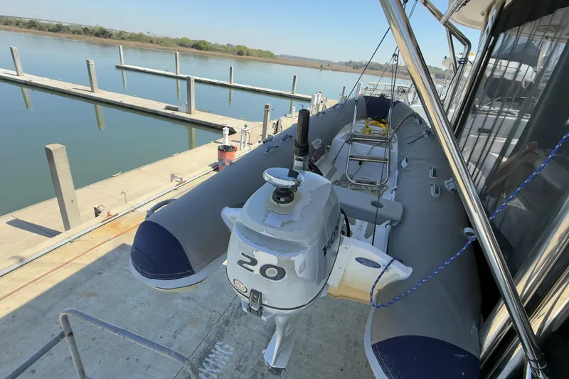 Slide: The Image of Inflatable boat with outboard motor docked beside Leopard 44 catamaran, 2014 model. - 40