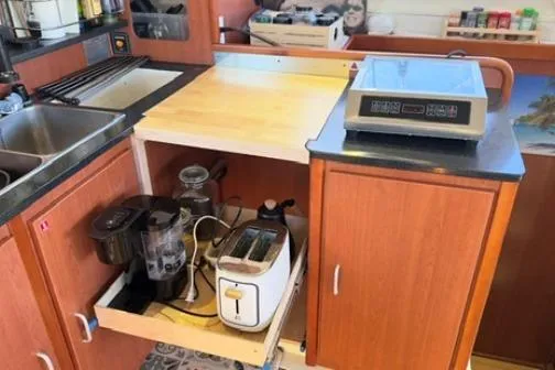 Slide: The Image of Kitchen area in a 2014 Leopard 44 yacht with appliances and storage. - 7