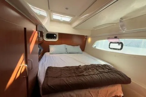 Slide: The Image of Cozy bedroom in 2014 Leopard 44 yacht with natural light and modern design. - 9