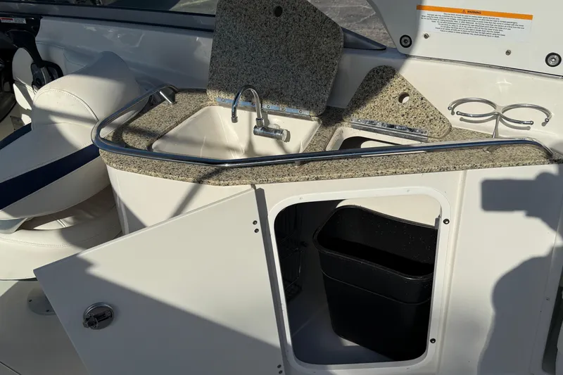 Slide: The Image of 2011 Monterey 264 FS boat interior with sink and storage compartment. - 17