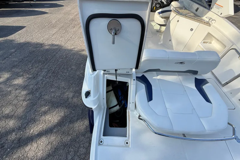 Slide: The Image of 2011 Monterey 264 FS boat with open storage compartment and seating area. - 21