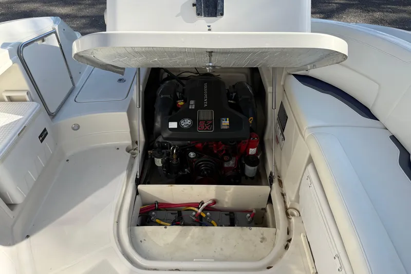 Slide: The Image of 2011 Monterey 264 FS boat engine compartment with open hatch, showcasing engine details. - 22